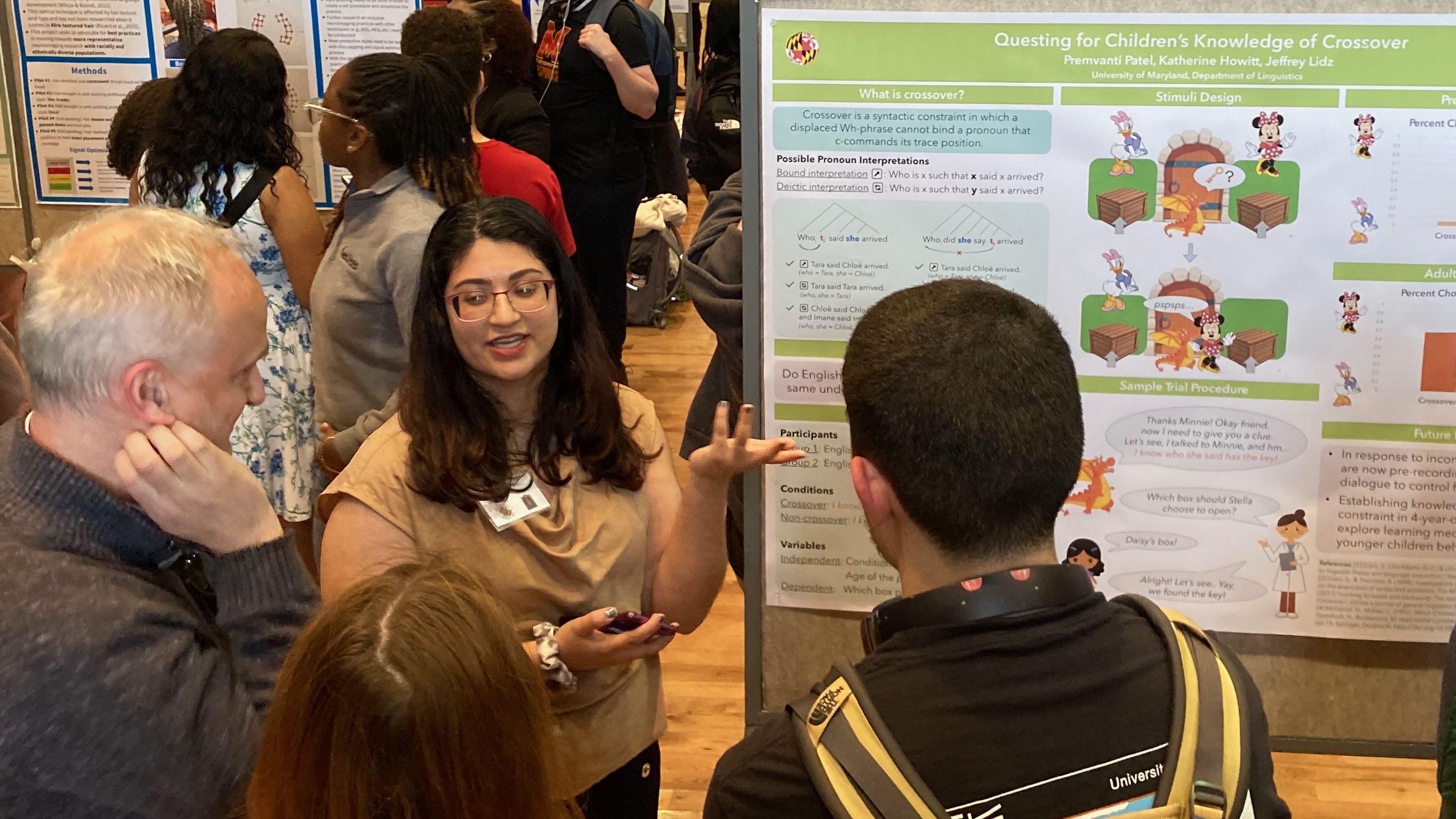 A young woman, Premvanti Patel, presenting a poster describing her research.